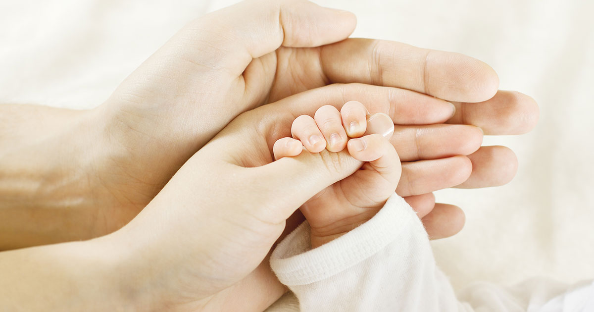 Family holding baby hand
